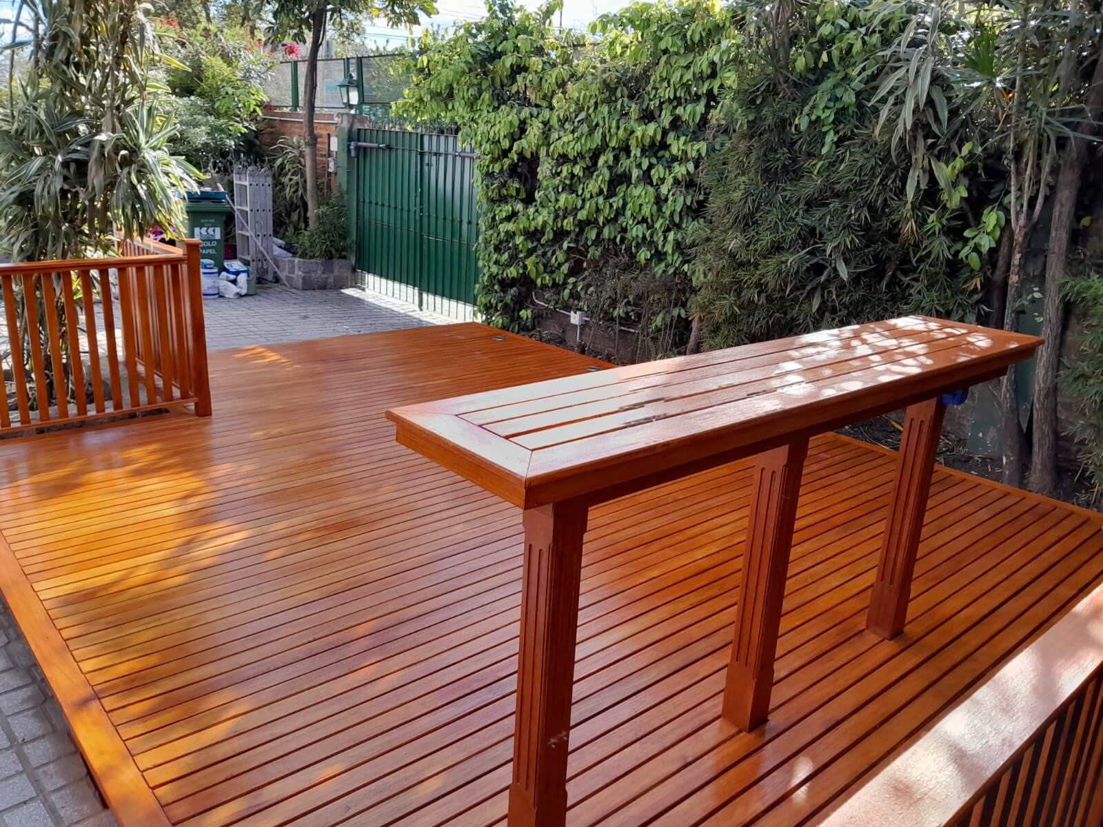 Deck de madera en jardin, con barra integrada.